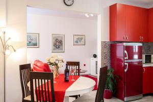 a kitchen with a table and a red refrigerator at Dori in Vela Luka