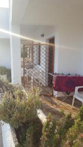 a house with a table and chairs on a porch at Aeolos Hotel Apartments in Gythio