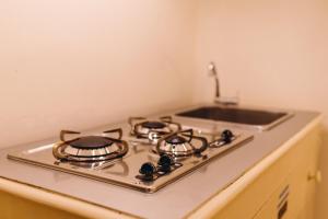 a white stove top oven sitting inside of a kitchen at Exclusive Aparthotel La Reunion in Ravenna