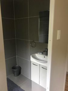 a bathroom with a sink and a mirror at Illovo Beach Inn in Amanzimtoti +20 photos