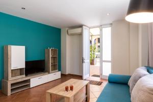 a living room with a couch and a tv at Mon-Repo Suites in Corfu Town