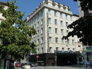 un gran edificio blanco en una calle de la ciudad en Hôtel du Helder, en Lyon