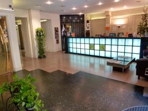 a lobby of a building with a table and a counter at Hôtel du Helder in Lyon