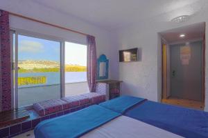 Postelja oz. postelje v sobi nastanitve UMH Tarik Hotel