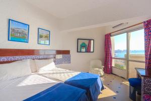 Postelja oz. postelje v sobi nastanitve UMH Tarik Hotel