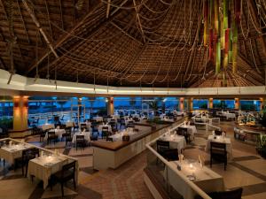 a restaurant with tables and chairs and a large ceiling at Hard Rock Hotel Riviera Maya- Heaven Section (Adults Only) All Inclusive in Puerto Aventuras