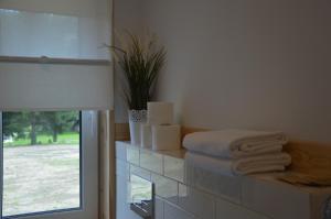 a room with a window with towels on a counter at Osada Leonówka Bieszczady in Cisna +68 photos