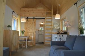 a living room and kitchen with a couch and a table at Osada Leonówka Bieszczady in Cisna