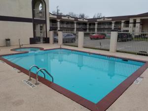 a large swimming pool in front of a building at HomeBridge Inn and Suites in Beaumont