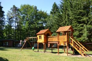 a playground with a slide and a play structure at Ośrodek leśny Rajsko w Zapuście in Zapusta