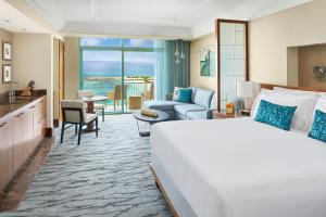 a hotel room with a large bed and a living room at The Reef at Atlantis in Nassau