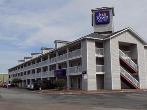 a building with a hotel with a sign on it at InTown Suites Extended Stay Austin TX - North Lamar in Austin