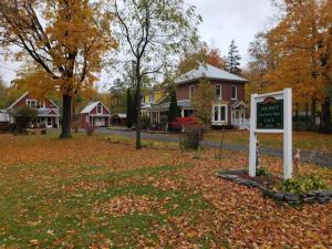 a sign in front of a house with leaves on the ground at Our Space the Perfect Place B&B in Picton