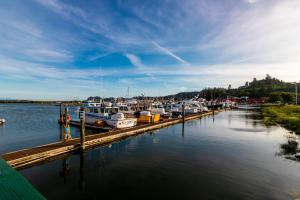 boats docked at a dock on a body of water at At The Helm Hotel in Ilwaco