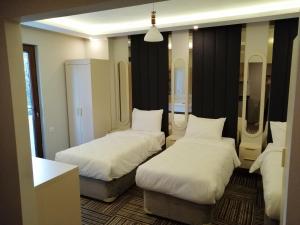 A bed or beds in a room at Alya Suite Hotel