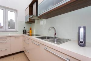 a kitchen with a sink and a window at Seafront Apartment Soline With Seaview in Soline
