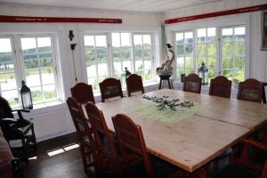 a dining room with a wooden table and chairs at Gamlestølen Fjellstue in Etnedal
