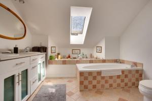 a bathroom with a large tub and a sink at Our Space the Perfect Place B&B in Picton +8 photos