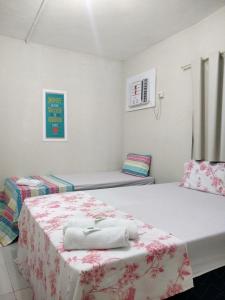 a room with two beds with towels on them at Casa da Esquina Pousada in Recife
