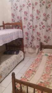 A bed or beds in a room at casa de temporada coroados