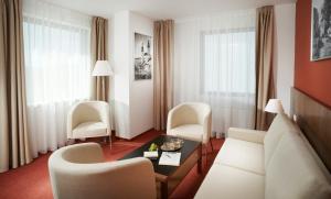 a living room with a couch and chairs and a table at Clarion Congress Hotel České Budějovice in České Budějovice
