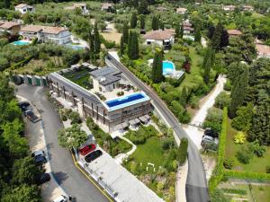 an aerial view of a large building with a road and cars at Lamasu RioVerde - Lago di Garda in San Felice del Benaco