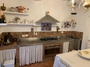 a kitchen with a sink and a stove top oven at Agriturismo La Casa dei Ricordi in Collesalvetti