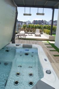 a hot tub on the roof of a building at ESPECTACULAR LOFT in Quito