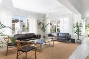 a living room with a couch and a table at Boutique Hotel Oriola in Cala de Sant Vicenc