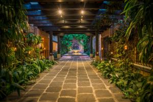 a hallway with plants and a fountain in a building at Porta Hotel Antigua in Antigua Guatemala
