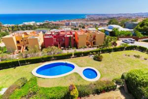 an aerial view of a house with a large swimming pool at Penthouse Reserva del Higueron in Benalmádena
