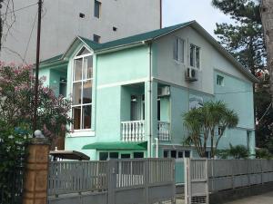 a blue house with a fence in front of it at Green house Ureki in Ureki