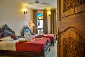 Voodi või voodid majutusasutuse Tembo Palace Hotel toas