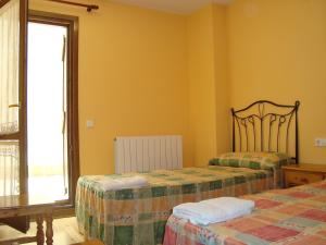 A bed or beds in a room at Apartamentos Saila