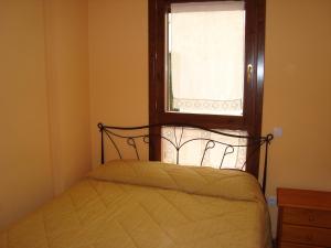 A bed or beds in a room at Apartamentos Saila