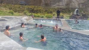 a group of people in a swimming pool at Casa de Mármol in Riobamba