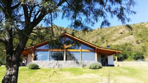 a house with a mountain in the background at Fincas del Faldeo in Villa General Belgrano