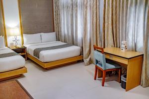 Ένα ή περισσότερα κρεβάτια σε δωμάτιο στο Crown Regency Courtyard Resort