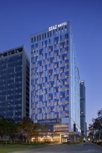 a tall building with a sign on top of it at MD HOTEL DOKSAN - Fomerly Staz Hotel Doksan in Seoul