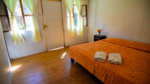 מיטה או מיטות בחדר ב-Tropical Lodge