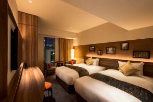 Postel nebo postele na pokoji v ubytování karaksa hotel premier Tokyo Ginza