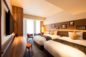 Postel nebo postele na pokoji v ubytování karaksa hotel premier Tokyo Ginza