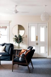 a living room with a couch and a table at Luxury on Loch in Beechworth