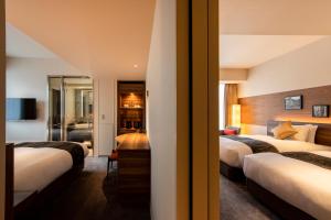 Postel nebo postele na pokoji v ubytování karaksa hotel premier Tokyo Ginza