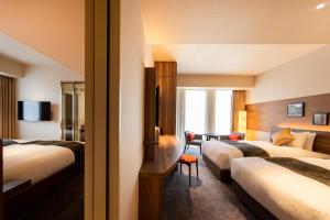 Postel nebo postele na pokoji v ubytování karaksa hotel premier Tokyo Ginza