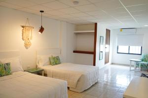 Postel nebo postele na pokoji v ubytování Hotel & Suites Arges - Centro Chetumal