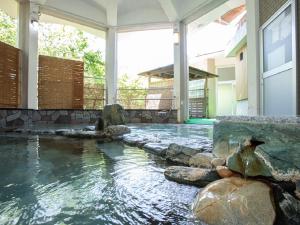 a swimming pool in the middle of a house at Hotel Okukujikan in Daigo