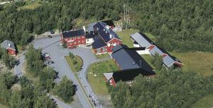 an aerial view of a group of houses in a forest at Lakselv Hotel in Lakselv