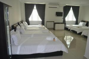 Postel nebo postele na pokoji v ubytování Hotel Mutiara KGMMB, Melaka