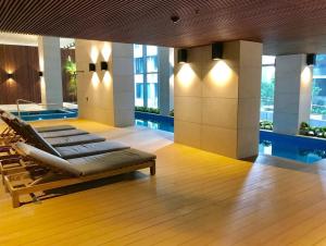 a hotel lobby with a pool and lounge chairs at ReadySet Apartments on Rose Lane in Melbourne